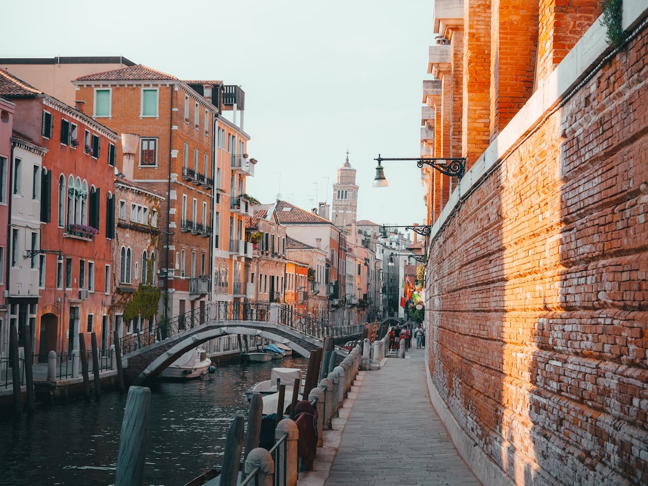 gallery-3 Charming view of a canal in Venice with colorful buildings and a bridge.